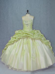 Un bonito tren de tul y organza sin mangas con cordones en un dulce vestido de quinceañera 16 en verde amarillo con abalorios y apliques
